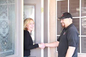 Technician providing onsite computer repair and greeting customer at home